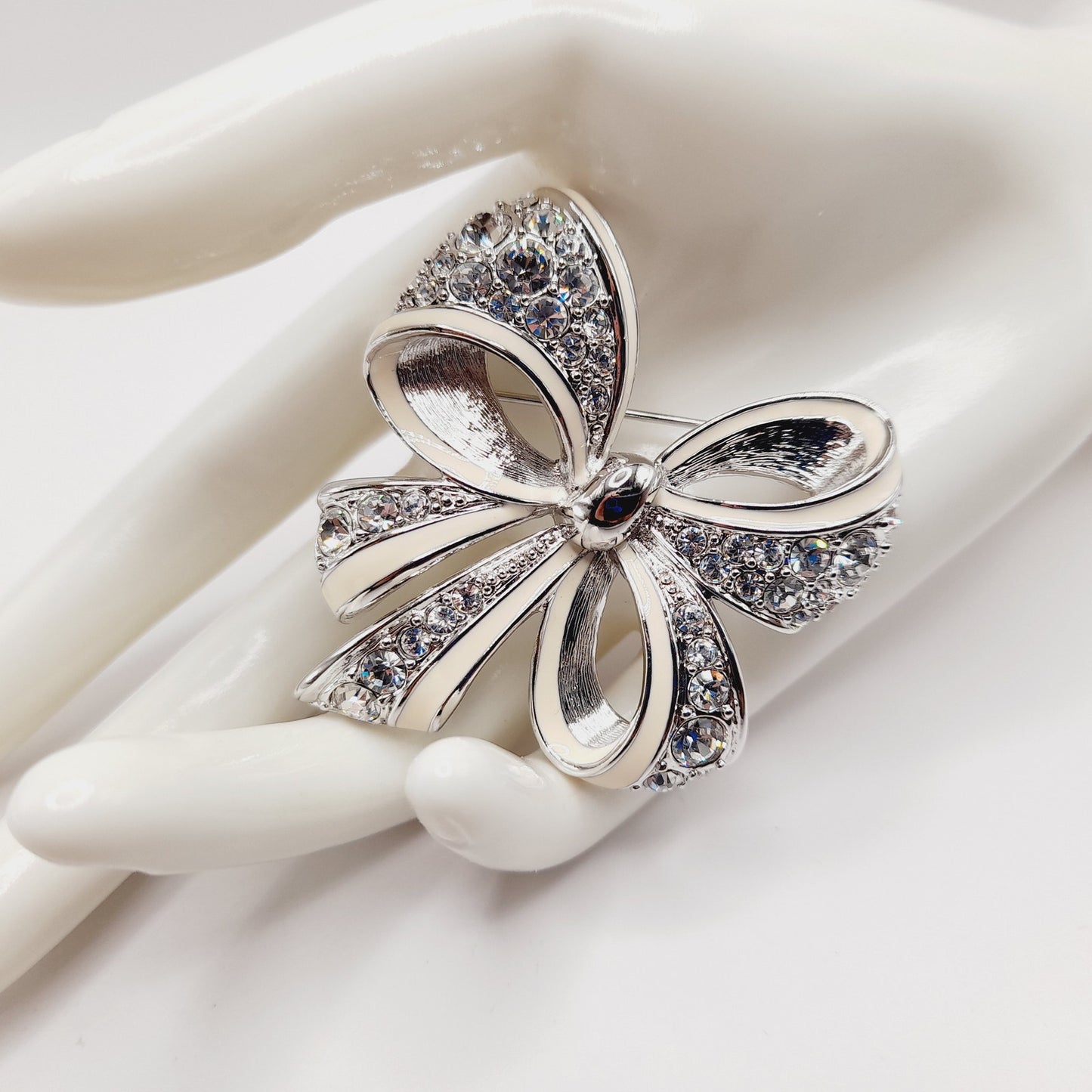 Vintage Nolan Miller Bow Brooch Rhodium Plated Clear Rhinestone White Enamel 2" Pin