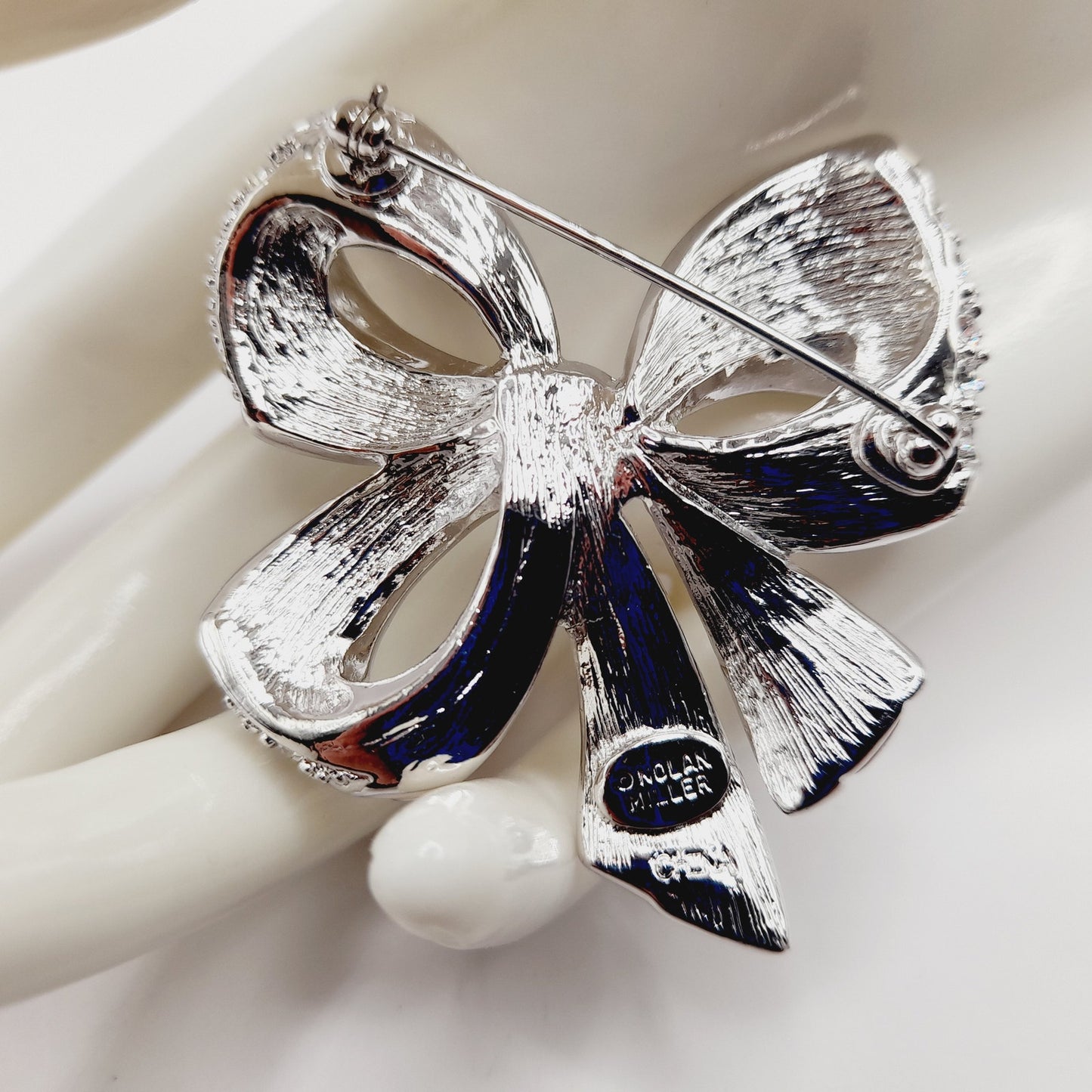Vintage Nolan Miller Bow Brooch Rhodium Plated Clear Rhinestone White Enamel 2" Pin