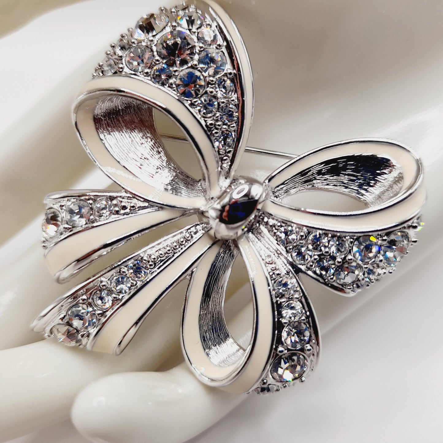 Vintage Nolan Miller Bow Brooch Rhodium Plated Clear Rhinestone White Enamel 2" Pin
