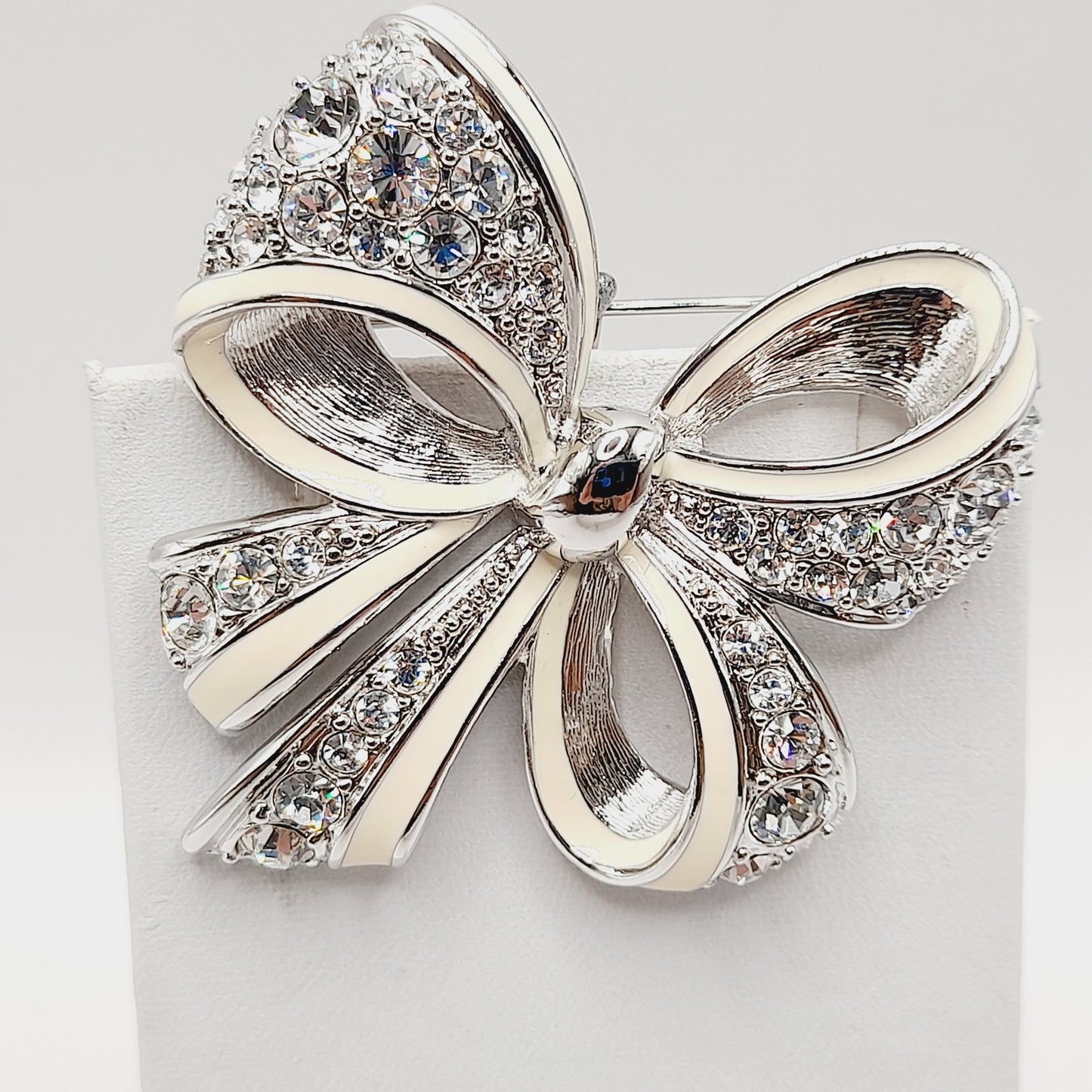 Vintage Nolan Miller Bow Brooch Rhodium Plated Clear Rhinestone White Enamel 2" Pin