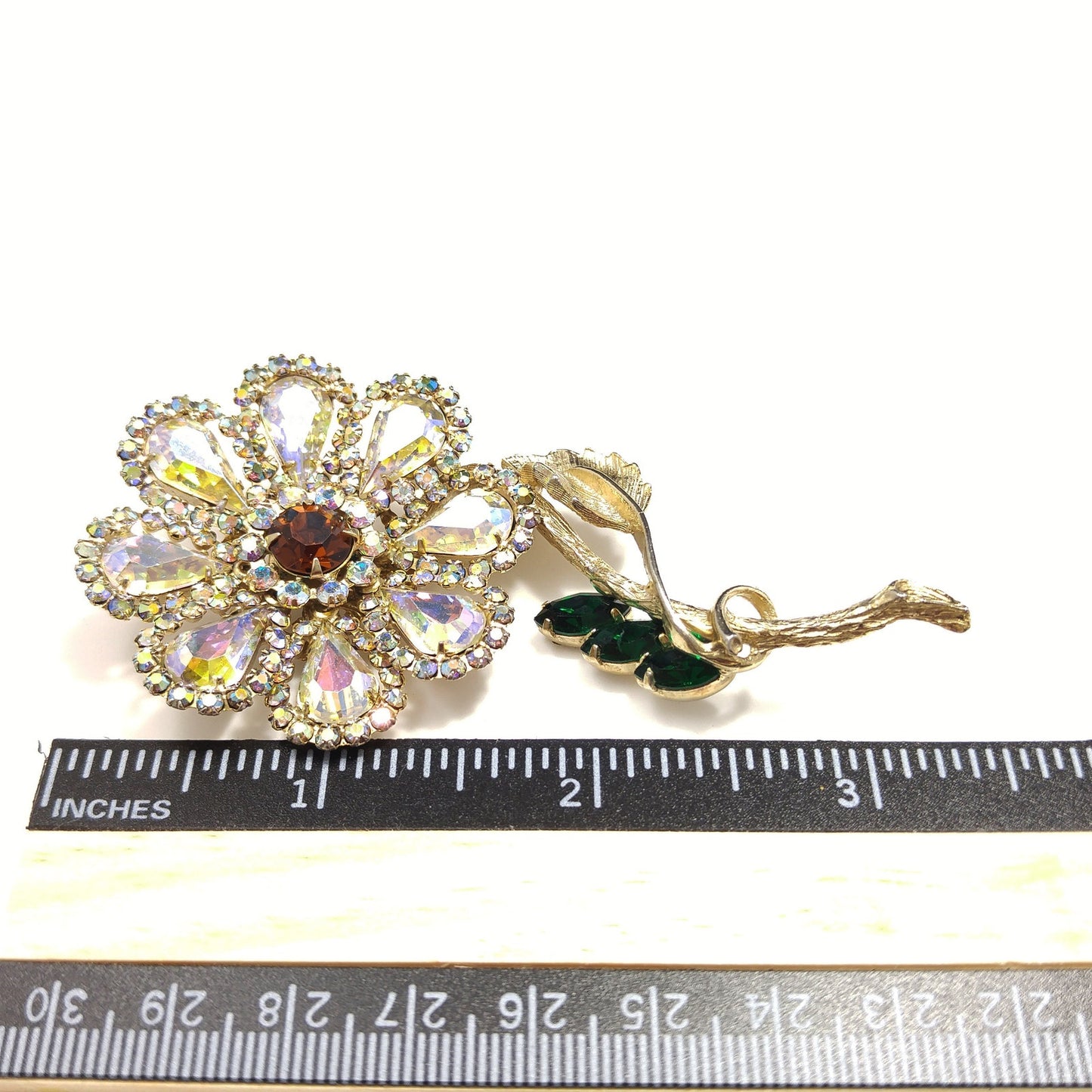 Weiss 1960s Aurora Borealis Rhinestone Flower Brooch with Green Leaves – Gold Plated