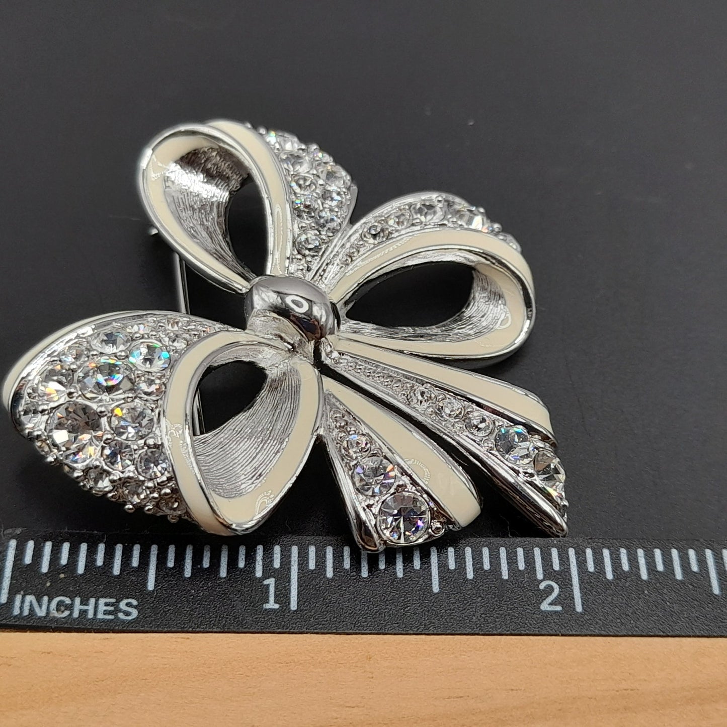 Vintage Nolan Miller Bow Brooch Rhodium Plated Clear Rhinestone White Enamel 2" Pin