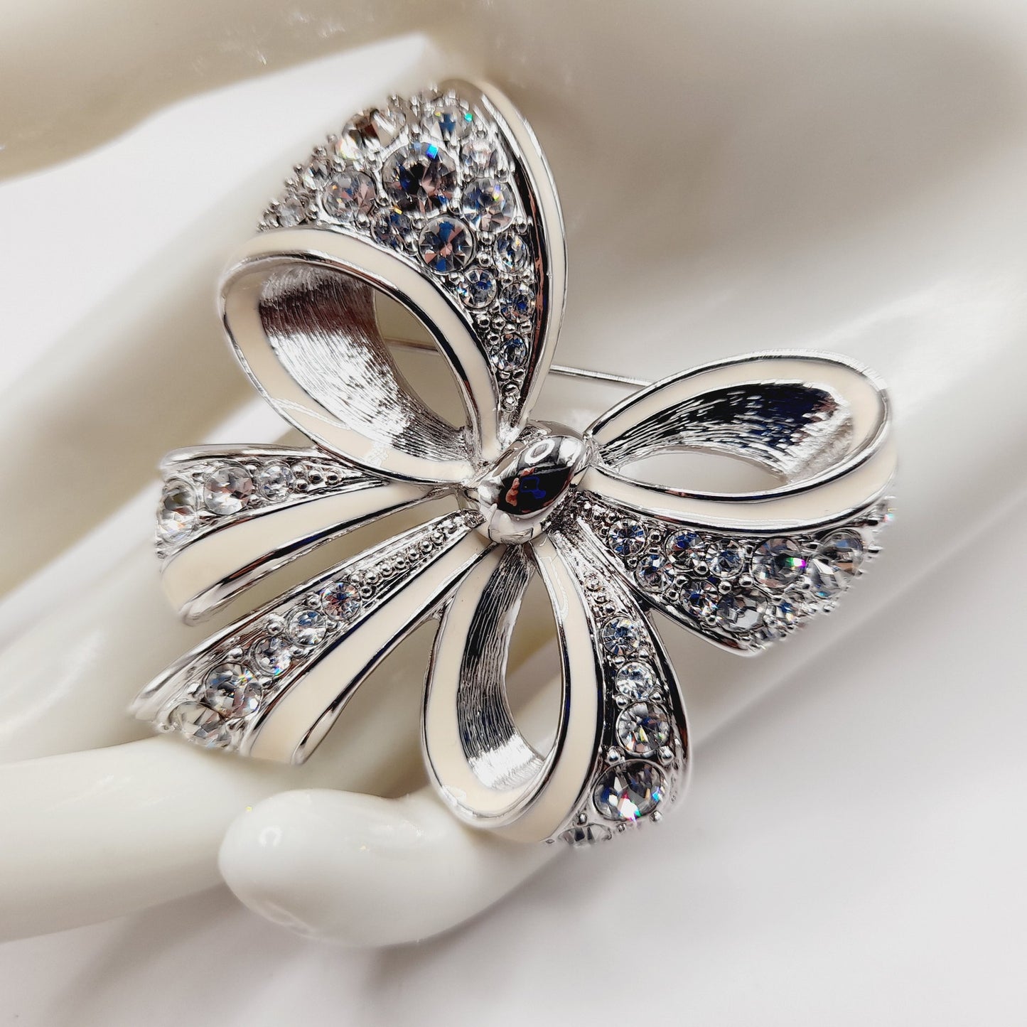 Vintage Nolan Miller Bow Brooch Rhodium Plated Clear Rhinestone White Enamel 2" Pin