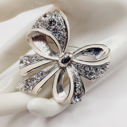 Vintage Nolan Miller Bow Brooch Rhodium Plated Clear Rhinestone White Enamel 2" Pin