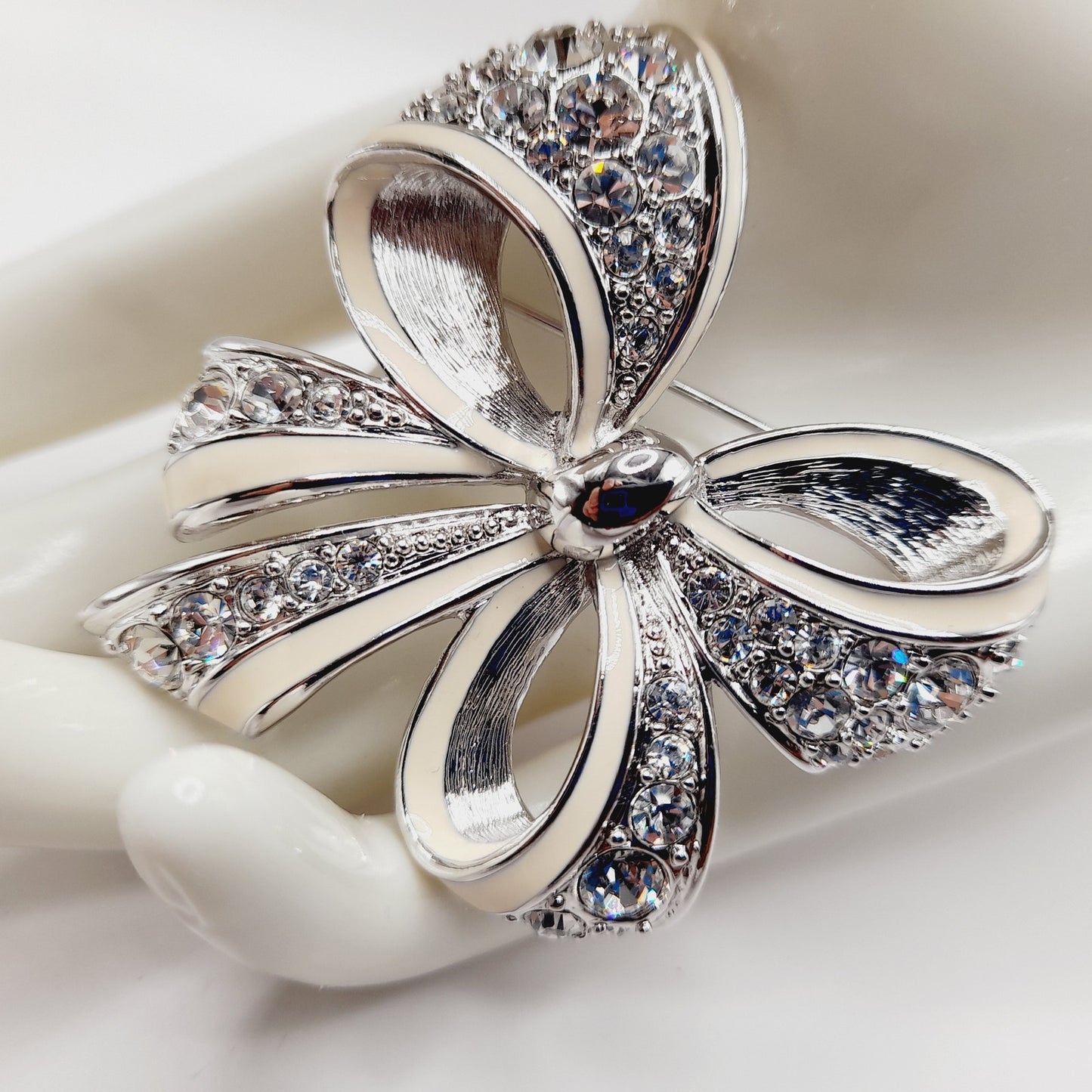 Vintage Nolan Miller Bow Brooch Rhodium Plated Clear Rhinestone White Enamel 2" Pin
